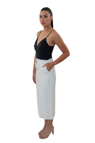 Side view of pinstripe midi skirt with high waist and pockets.