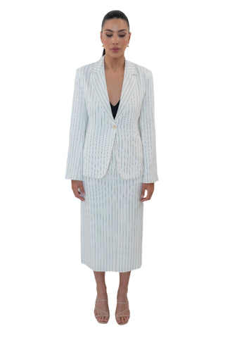 Womens linen pinstripe blazer worn closed over matching midi skirt.