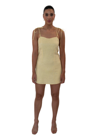 Yellow linen mini dress with tie shoulders.